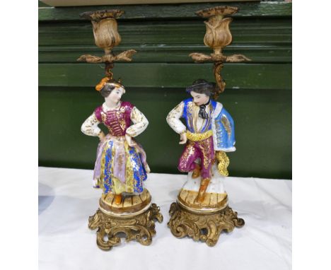 Two continental porcelain style figural candlestick bases with brass coloured metal attachements