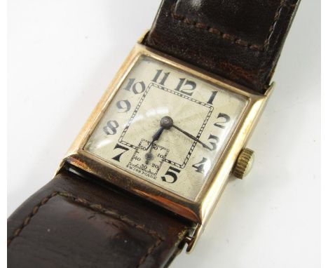 An early 20thC 9ct gold gentleman's tank wristwatch, square dial with engine turned decoration bearing Arabic numerals, inclu