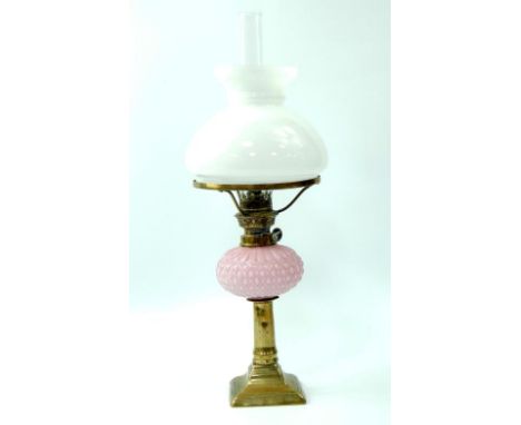 An early 20thC brass and pink opaline glass oil lamp, with a white glass shade, 42.5cm high.