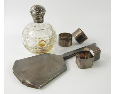 A Victorian cut glass scent bottle, with a silver screw lid with embossed decoration, London 1894, four napkin rings, 6.20toz