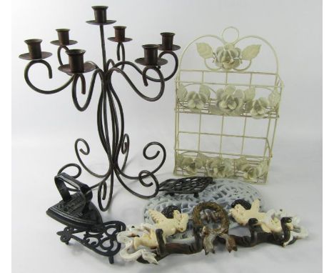 A cast iron seven branch chandelier, two tier wall mounted plant holder, flat iron and stand, two iron kettle stands and a co