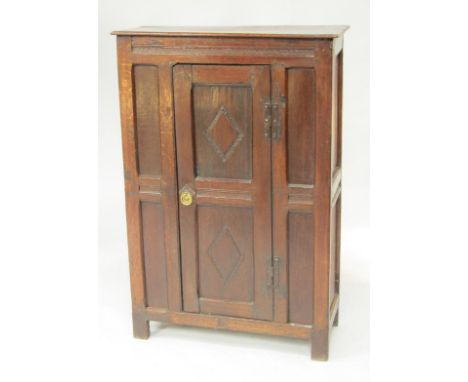 A 19thC oak cupboard, with a panelled door, enclosing a single shelf, raised on straight legs, possibly converted from an ear