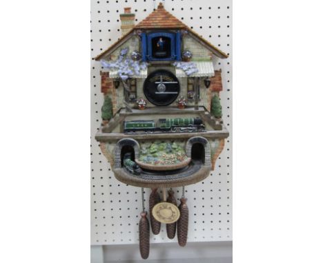 A Flying Scotsman battery operated cuckoo clock, 57cm high.