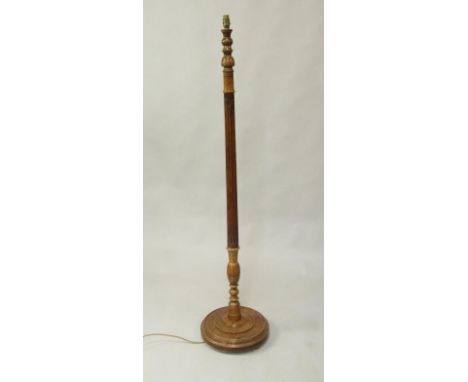 A fluted and turned oak standard lamp, raised on a circular base, 158cm high.