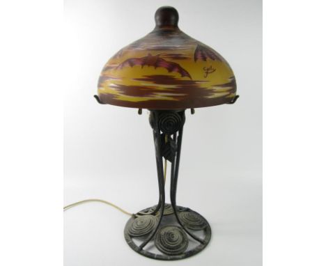 A Galle style cast iron table lamp, with glass shade overlaid with bats, 63cm high.