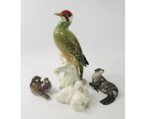 A Rosenthal porcelain figure of a sea lion, Karl Ens figure of a Woodpecker, Copenhagen group of a pair of sparrows, and a Na