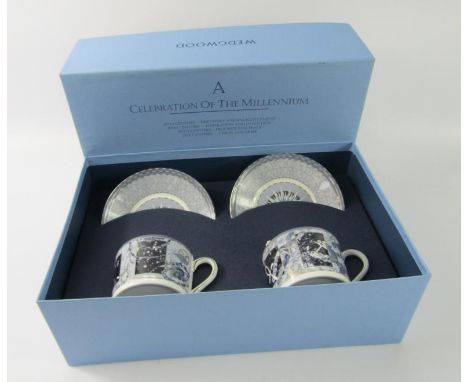 A pair of Wedgwood porcelain coffee cups and saucers, A Celebration of the Millennium, boxed.