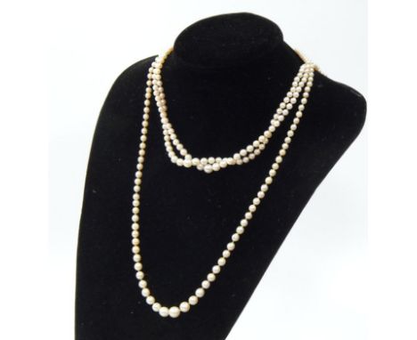 A graduated pearl necklace, possibly natural, comprising 106 pearls on a yellow metal, ruby and diamond set clasp, together w