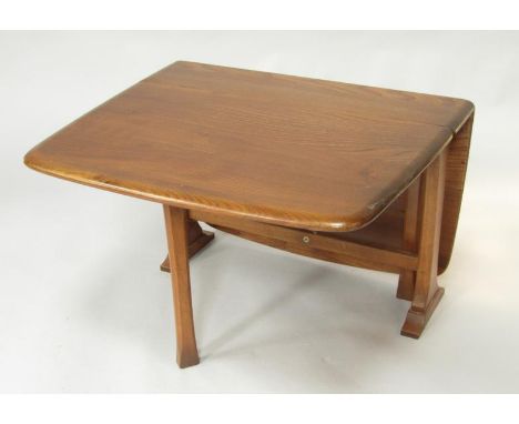 An Ercol elm drop leaf occasional table, 69cm x 101cm x 46.5cm.