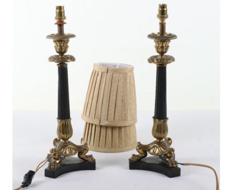 A pair of French gilt and patinated metal candlestick table lamps in Louis Philippe taste, later 19th century and adapted for