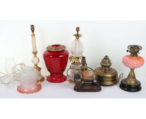 A good selection of table lamps, including two Victorian oil lamps with cranberry glass shades, one Lampe Veritas, with a Fre