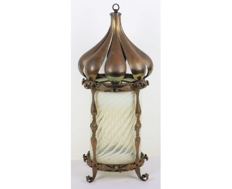 An Art Nouveau brass and glass lantern, lobed brass top with iridescent spiral glass, crack to glass (see image)66cmH Note: N