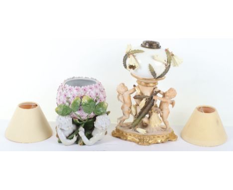 A 19th century Dresden porcelain compote and Moore Brothers lamp, the compote with crossed swords to base, cherubs draped in 