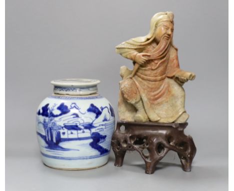 A Chinese soapstone carving of a deity and a similar early 19th century blue and white jar, tallest 30cm