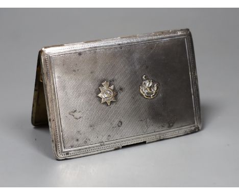 A Finnigans silver engine turned cigarette case with gilt interior mounted with gold Manchester Regiment 'Egypt' badge and fa