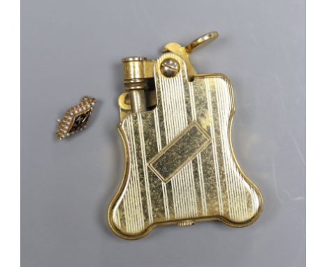 A Russian enamelled and seed pearl set brooch initialled KAOT, 1.75cm, gross 2.5 grams and a gold plated Ronson automatic cig