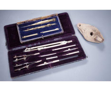 Two cased drawing sets and a Roman oil lamp