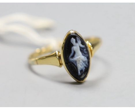 An 18ct gold and black cameo dress ring, carved with a dancing lady, size T, gross 2.8 grams