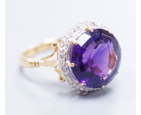 An 18ct gold and platinum, amethyst and diamond circular cluster ring, size M, gross 5.7 grams