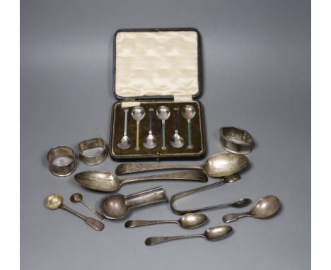 A pair of George III bright cut silver table spoons, three later assorted napkin rings, a cigar stand, a pair of tongs, five 