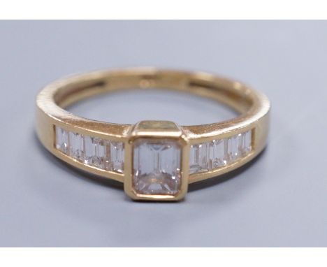 Am 18ct gold and diamond dress ring, with central octagonal cut stone and emerald cut shoulders, size O, gross weight 3.4 gra