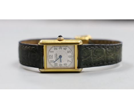 A lady's Must de Cartier silver gilt wristwatch, with quartz movement and blue cabochon winder
Condition:&nbsp;Not currently 