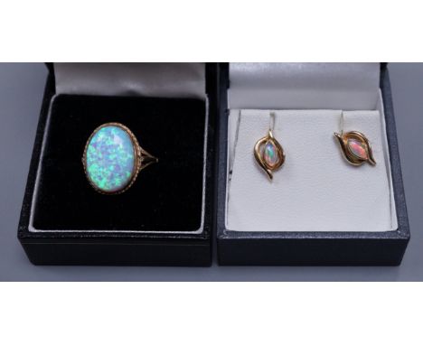 A 9ct gold white opal doublet ring, size O and a pair of white opal mounted ear studs