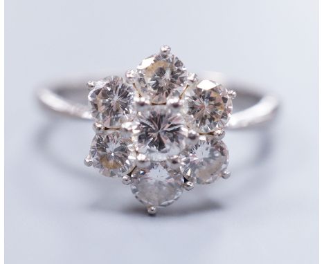 An 18ct white gold seven stone diamond cluster ring, size M, gross 4.1 grams
Each stone approx. .25ct.