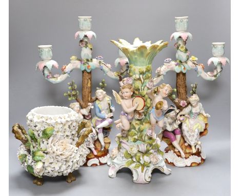 A pair of continental porcelain figural candlesticks and a similar candelabra base, together with a encrusted porcelain two h