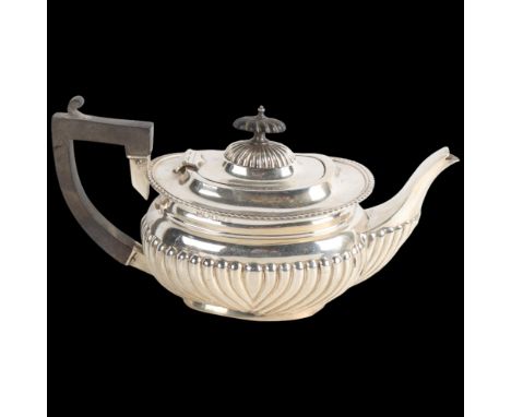 An Edwardian silver bachelor's teapot, William Aitken, Birmingham 1902, oval bulbous form with half fluted decoration and ebo