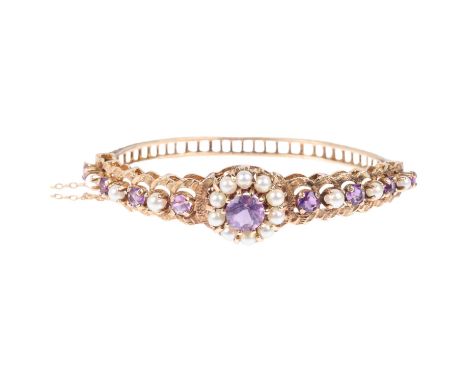 A late 20th century 9ct gold amethyst and pearl cluster hinged bangle, no maker's mark of date letter, setting height 16.1mm,