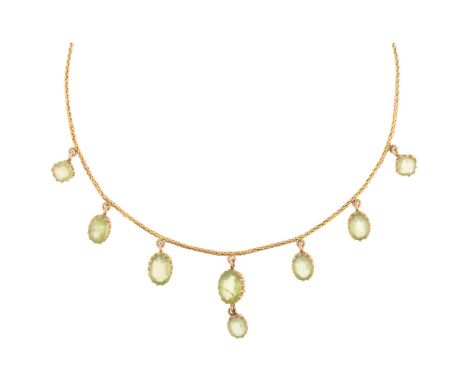 An Edwardian peridot fringe necklace, circa 1910, claw set with oval mixed-cut peridot drops, on unmarked gold foxtail link c