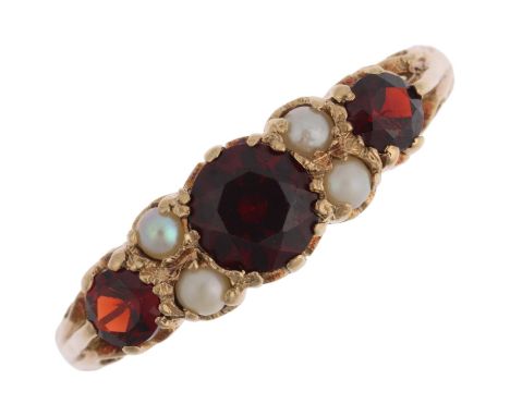 A mid-20th century 9ct gold seven stone garnet and pearl half hoop ring, London 1963, setting height 7mm, size Y, 3.8gNo dama