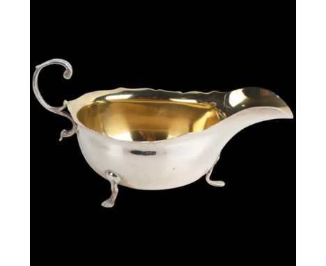An Edwardian silver sauce boat, Wilson & Gill, London 1903, C-shaped handle with gilt interior, 15cm, 2.2ozNo damage or repai