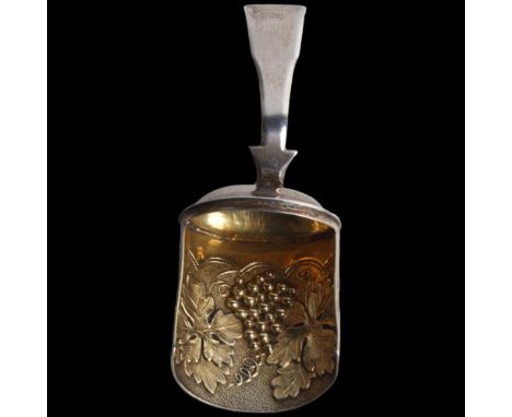 A George III silver shovel tea caddy spoon, William Lea & Co, Birmingham 1816, relief embossed and gilded grapevine decoratio