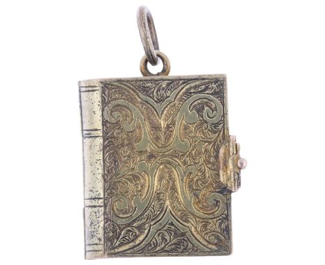 A Victorian novelty book photo locket pendant, the engraved covers opening to reveal arched interior with hinged latch, appar