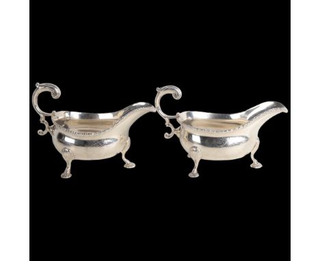 A fine pair of George II silver sauce boats, Robert Innes, London 1751, gadrooned rims with scrolled acanthus leaf handles, s
