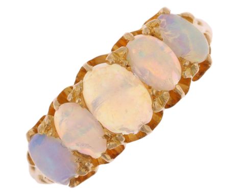 An early 20th century graduated five stone opal half hoop ring, set with oval cabochon opals, apparently unmarked settings te