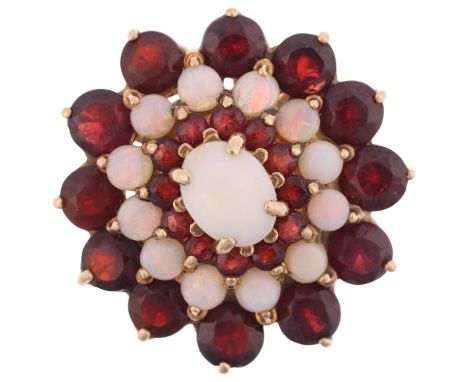 A large late 20th century 9ct gold opal and garnet flowerhead cluster ring, maker OMJ, London 1974, set with cabochon opals a