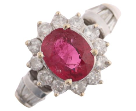 An 18ct white gold ruby and diamond flowerhead cluster ring, claw set with 1.1ct oval mixed-cut ruby, surrounded by modern ro