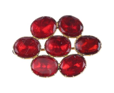 A Georgian flat-top red paste cluster mourning brooch, circa 1820, apparently unmarked foiled closed-back settings, 40.2mm, 7