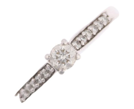 A modern 9ct white gold 0.15ct solitaire diamond ring, claw set with modern round brilliant-cut diamonds and diamond set shou