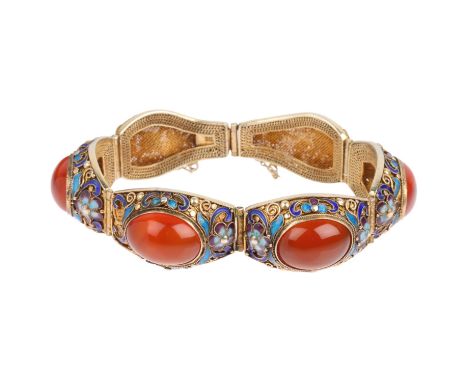 A Chinese silver-gilt carnelian and enamel panel bracelet, band width 19.5mm, internal circumference 18cm, 40.9g1 enamel flow