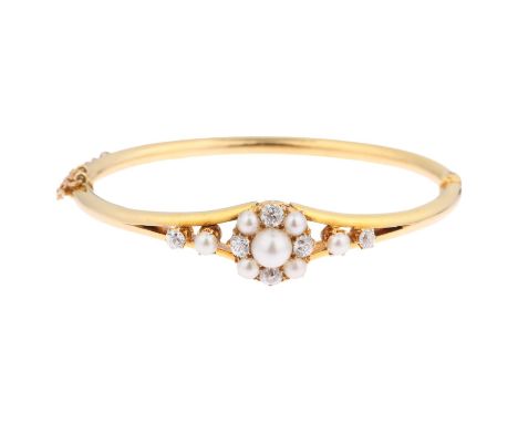 A Victorian pearl and diamond cluster hinged bangle, unmarked 18ct gold settings with old-cut diamonds, total diamond content