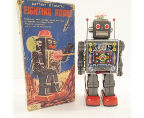 A vintage circa 1960s battery operated Fighting Robot by S.H Toys. In original box. 