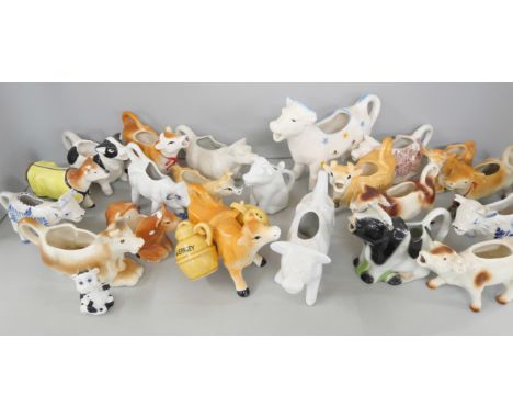 A collection of ceramic creamers/milk jugs in the form of cows 