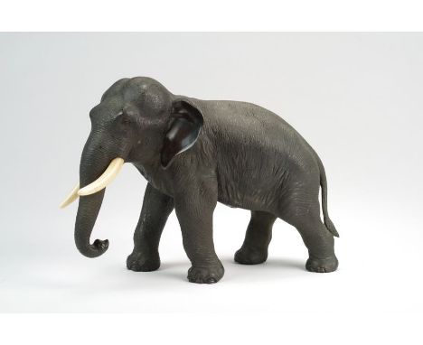 A Japanese bronze figure of an elephant by Genryusai SeiyaMeiji periodModelled standing four square with trunk down and curle