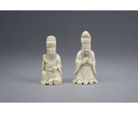 A pair of Chinese carved ivory snuff bottles Late Qing Dynasty Each modelled as an official, one seated and holding a scroll,