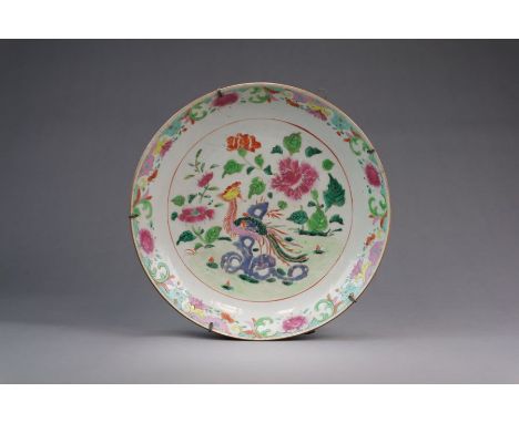 A large Chinese famille rose dish, 18th Century Of plain circular form, the well painted in colours with a phoenix bird besid