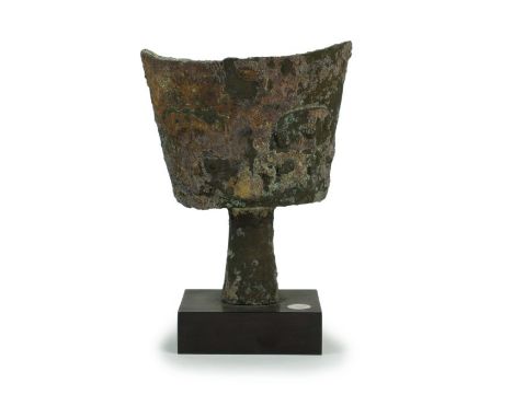 A Chinese bronze ceremonial bell, Nao Shang Dynasty (1600-1027 BC) Of cup form with scooped rim and raised on a tapering hand